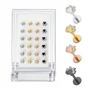 Wholesale G23 titanium jeweled animal paw labret studs assorted color variation image with clear acrylic display stand and individual silver, gold, rose gold, and black paw jewelry pieces.