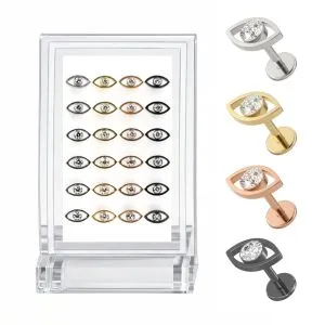 Wholesale G23 titanium jeweled evil eye labret studs assorted color variation image with clear acrylic display stand and individual silver, gold, rose gold, and black evil eye jewelry pieces.