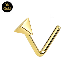 Close-up macro view showing the sharp geometric facets and mirror-finish on a 9k gold sculpted pyramid nose stud.