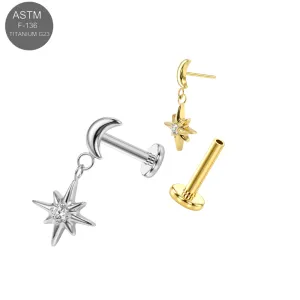 ASTM F-136 implant grade titanium threadless flat back labret jewelry featuring a polished crescent moon top with a dangling North Star charm and clear CZ center accent, in plain titanium and Gold PVD variants.