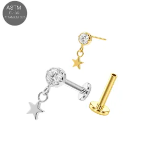 ASTM F-136 implant grade titanium threadless flat back labret jewelry featuring a prong set clear round CZ main stone with a dangling star charm, in plain titanium and Gold PVD variants.