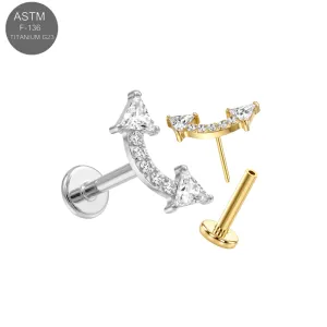 ASTM F-136 implant grade titanium threadless labret studs featuring a curved chevron arc cluster top with a central triangle-cut CZ stone flanked by round crystals in plain silver and gold PVD options.